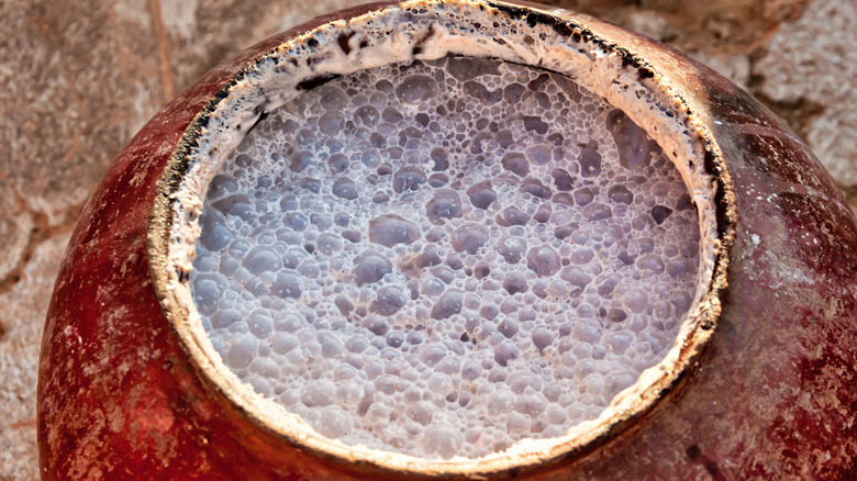 A gourd with naturally fermenting Ethiopian beer