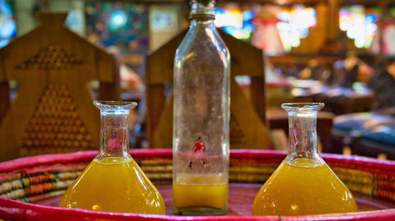 Tej Ethiopian honey wine served in three glass flasks