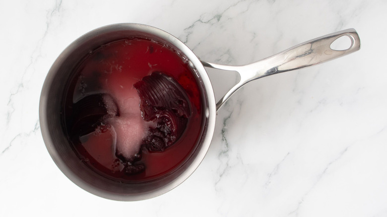 Cranberry sauce, sugar, and liquid in saucepan