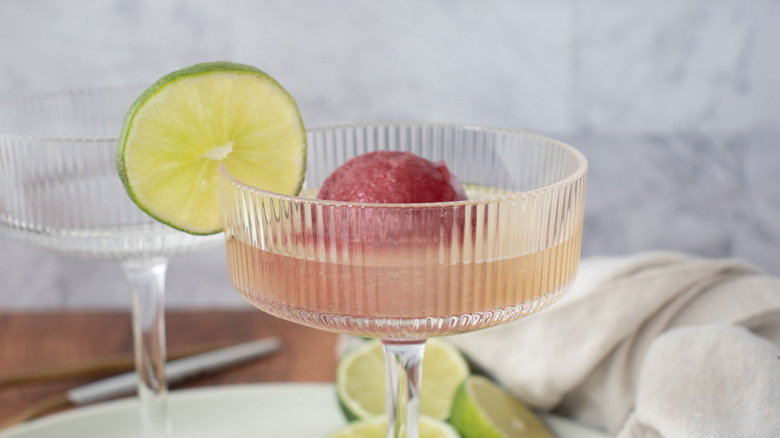 Sorbet cocktail in glass with lime garnish
