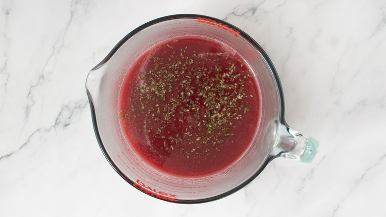 Cranberry juice with lime zest on top