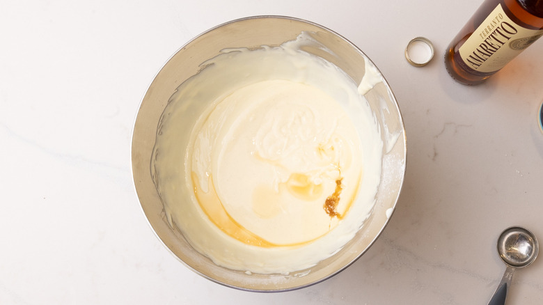 adding amaretto into custard mixture