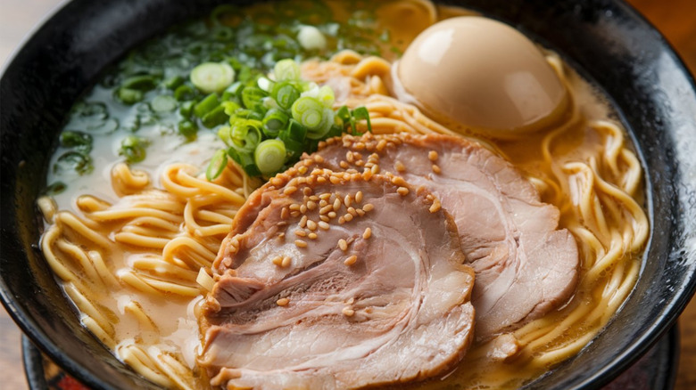 Hakata ramen in creamy pork broth with spring onions, noodles, and egg