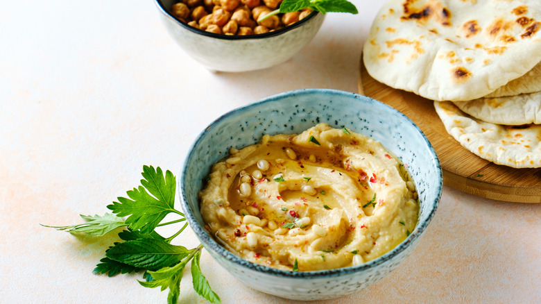 Bowl of hummus with pine nuts