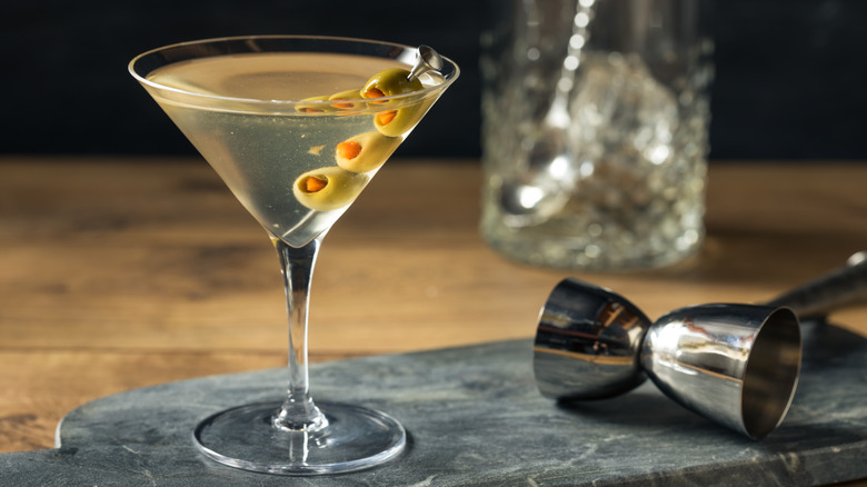 Dirty martini with olive skewer