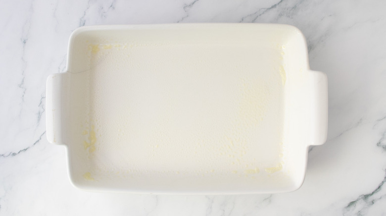 White casserole dish coated in cooking spray