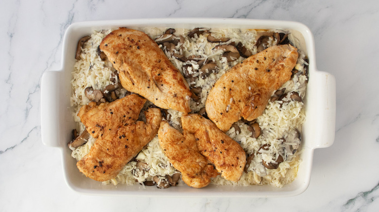 Noodle casserole dish topped with seared chicken