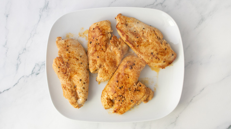 Seared chicken breasts on a large white plate