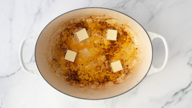Butter in a large Dutch oven used to sear chicken