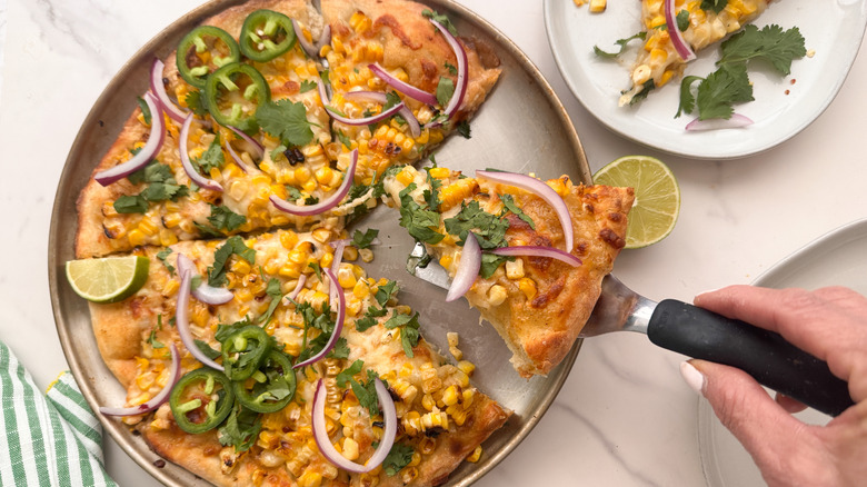 hand serving pizza slice