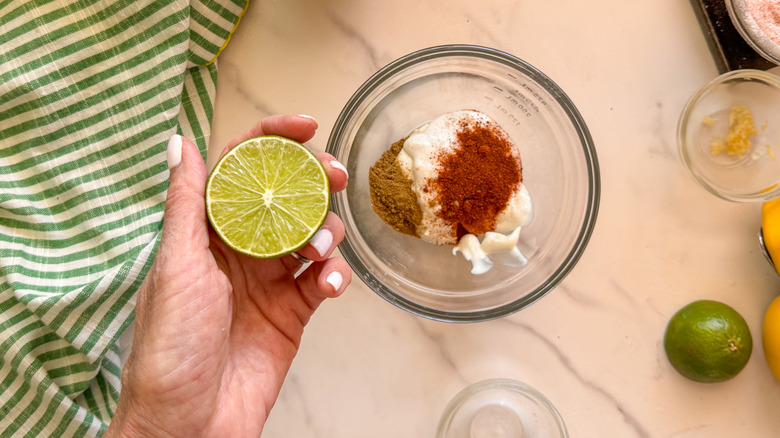 hand adding lime to bowl