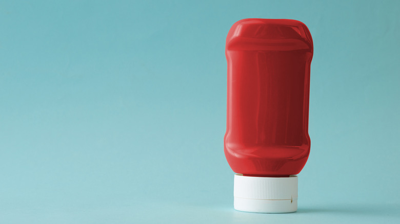 Ketchup bottle on a light blue background