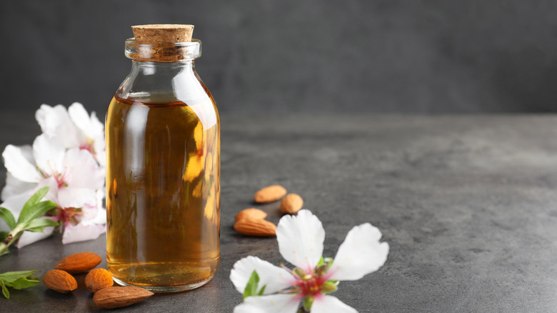 A small, rustic bottle of almond extract.