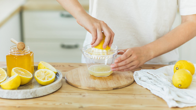 Person juicing a lemon