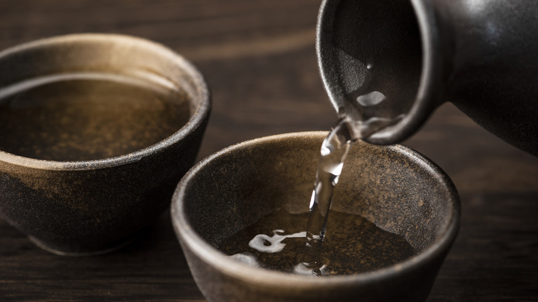 Pouring cups of sake.