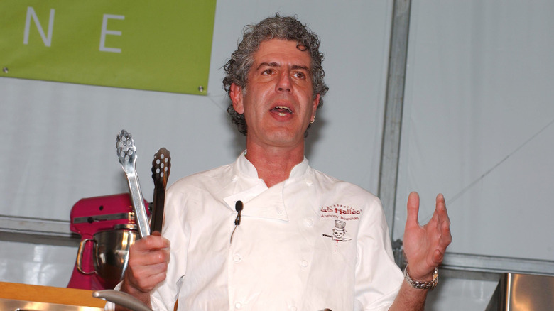 Celebrity chef Anthony Bourdain on stage at an event.