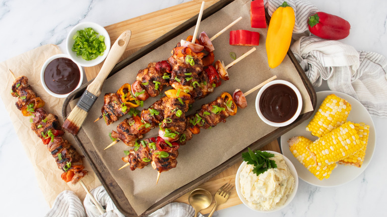 Overhead shot of grilled chicken skewers with barbecue sauce