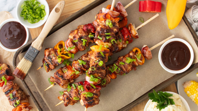 Overhead shot of grilled chicken skewers with barbecue sauce