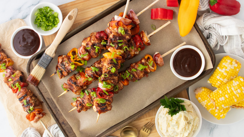 Overhead shot of grilled chicken skewers with barbecue sauce