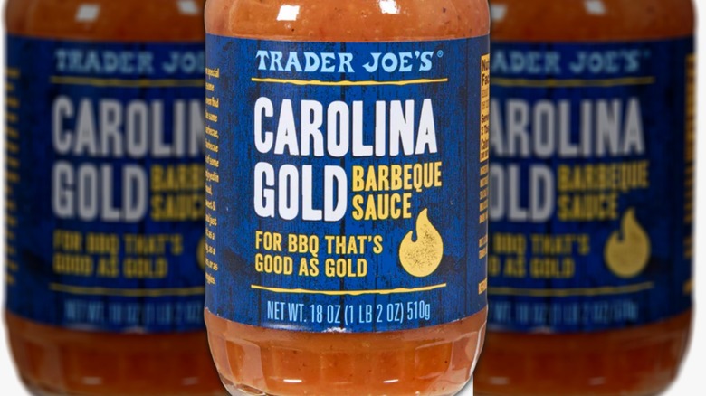 Closeup of bottle of Carolina Gold Barbeque Sauce with white and gold lettering on a blue background