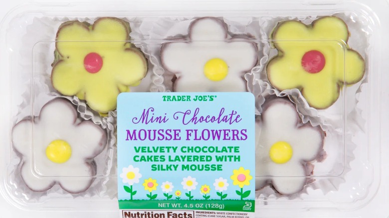 Package of flower-shaped mousse cakes, some frosted in white and others in yellow