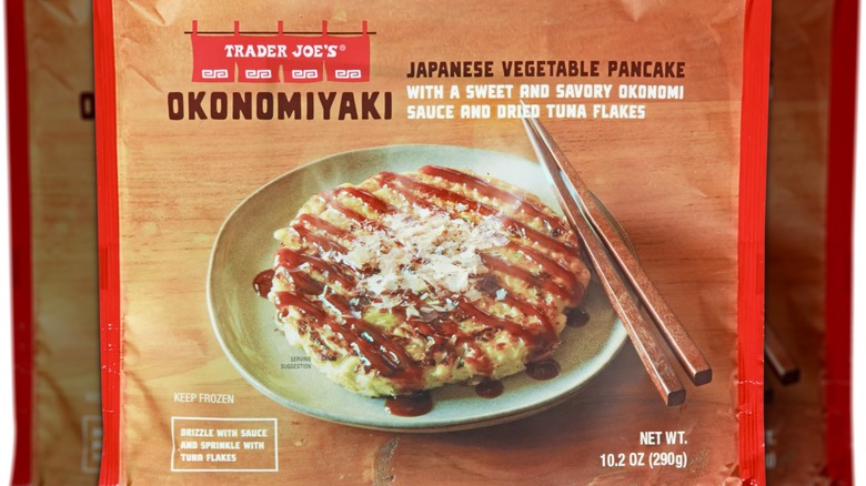 Package of okonomiyaki showing one okonomiyaki pancake on a plate with chopsticks next to it