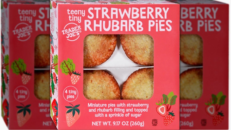 Box of four small strawberry rhubarb pies with white lettering on a red background