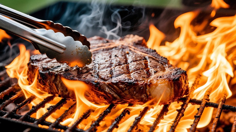 steak being seared on a grill to develop a crispy crust