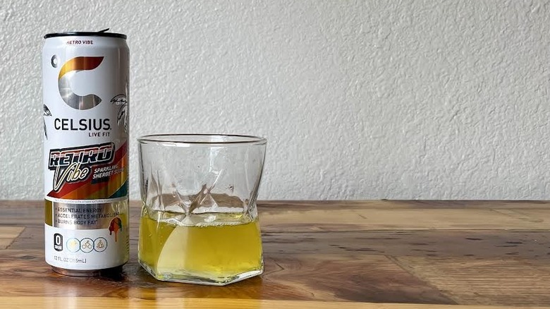 Can and glass of Celsius Retro Vibe Sparkling Sherbert Slush on a wooden tabletop