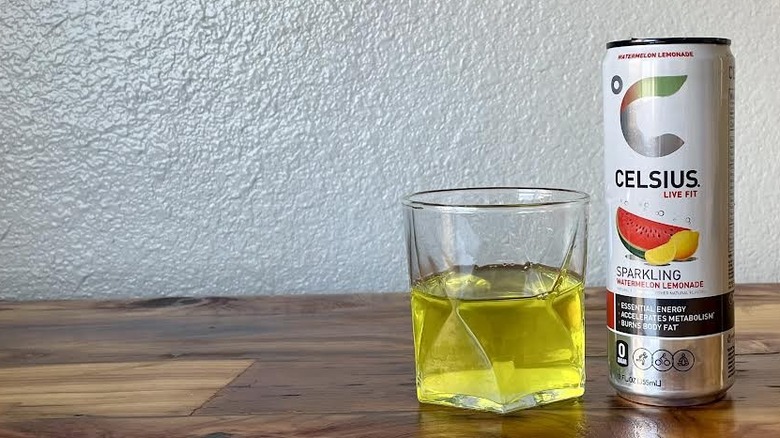 Can and glass of Sparkling Watermelon Lemonade Celsius on a wooden tabletop