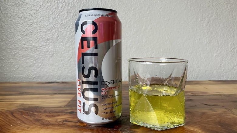 Can and glass of Essentials Watermelon Ice Celsius on a wooden tabletop