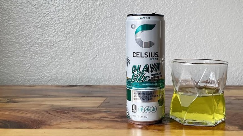 Can and glass of Playa Vibe Sparkling Piña Colada Celsius on a wooden tabletop