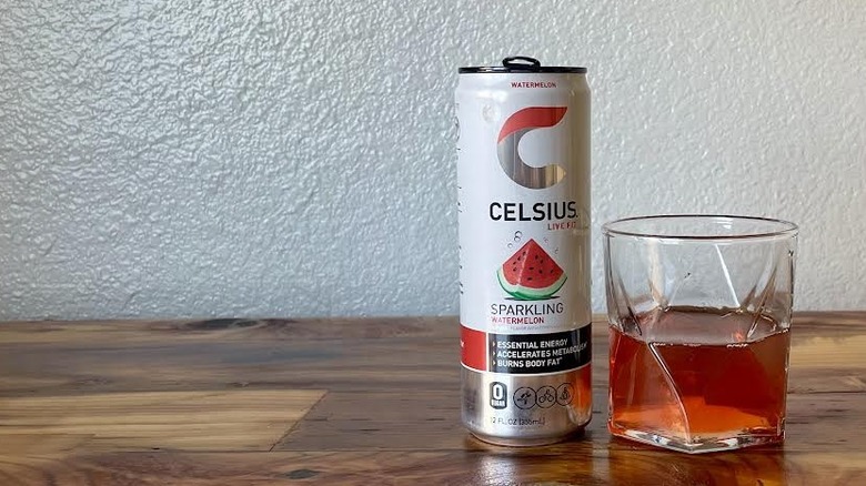 Can and glass of Sparkling Watermelon Celsius on a wooden tabletop