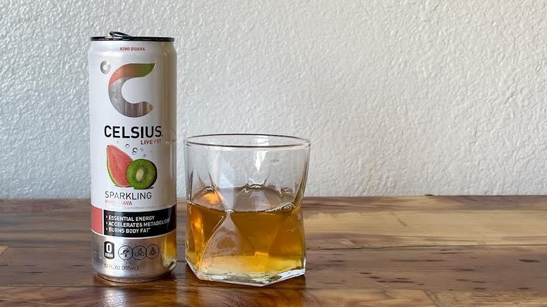 Can and glass of Sparkling Kiwi Guava Celsius on a wooden tabletop