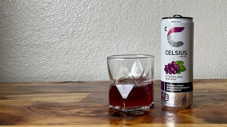 Can and glass of Sparkling Grape Rush Celsius on a wooden tabletop