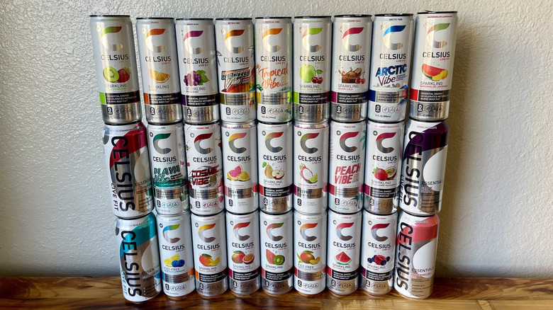 Collection of Celsius cans stacked on a wooden tabletop