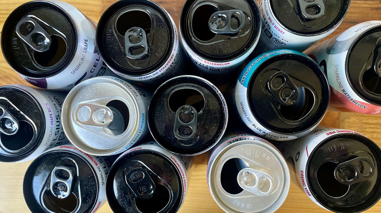 Overhead view of opened cans of Celsius with silver and black tops