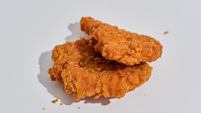 Two buffalo chicken tenders on a table.