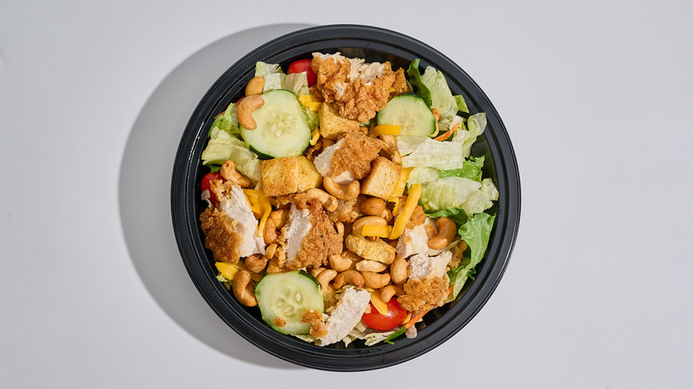 Chicken cashew salad in a bowl on a table.