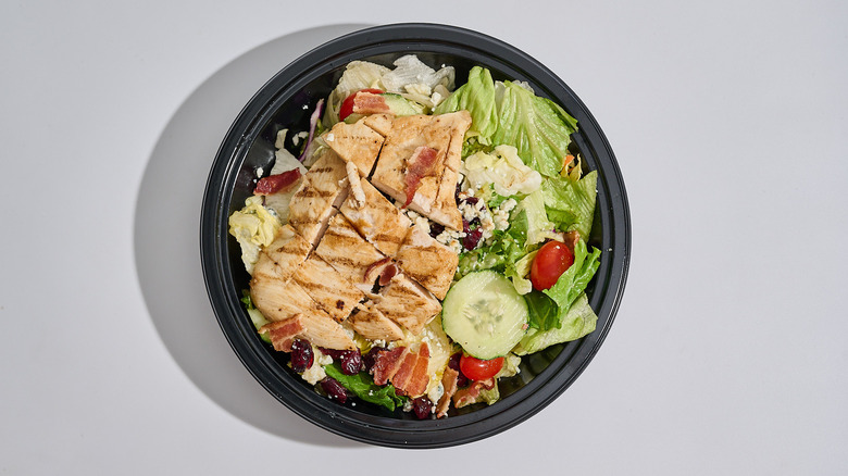 Cranberry bacon bleu salad in a bowl on a table.