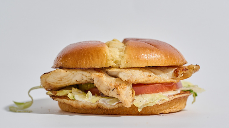 Grilled chicken sandwich on a table.