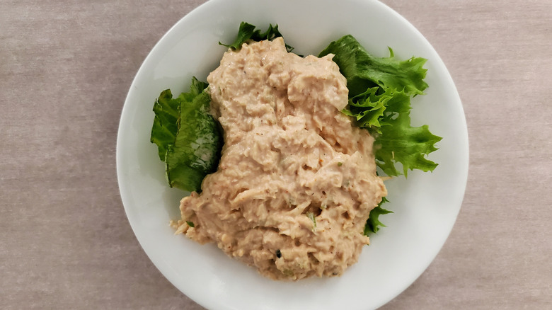 Barbie-Q chicken salad from Chicken Salad Chick on a lettuce leaf on a small, white plate