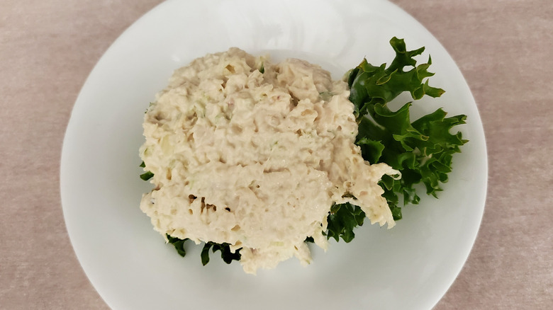 Dixie Chick chicken salad from Chicken Salad Chick on a lettuce leaf on a small, white plate