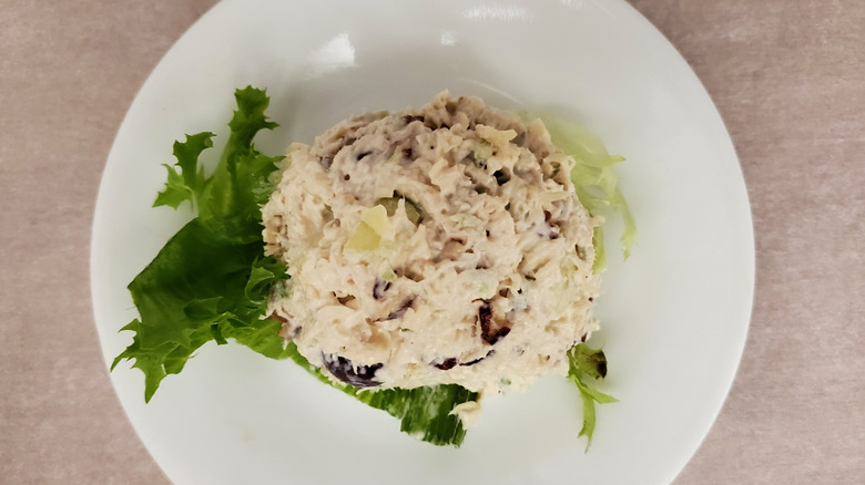 Fruity Fran chicken salad from Chicken Salad Chick on a lettuce leaf on a small, white plate