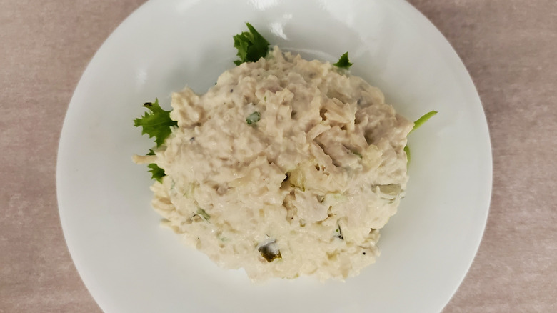 Jill Pickle chicken salad from Chicken Salad Chick on a lettuce leaf on a small, white plate