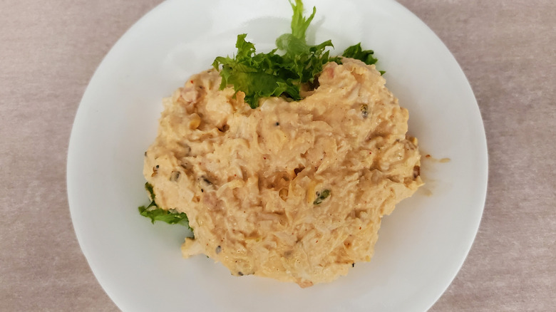 Kickin' Kay Lynne chicken salad from Chicken Salad Chick on a lettuce leaf on a small, white plate