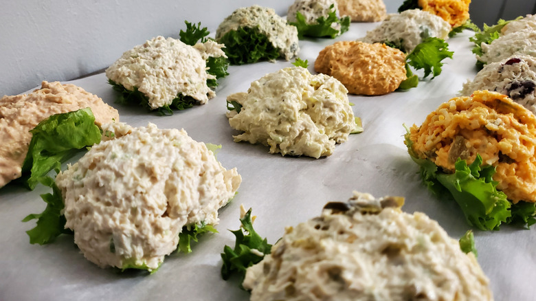 Various types of chicken salad from Chicken Salad Chick on individual lettuce leaves arranged in lines