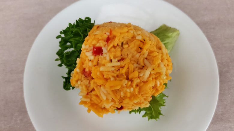 Southern Pimento Cheese chicken salad from Chicken Salad Chick on a lettuce leaf on a small, white plate
