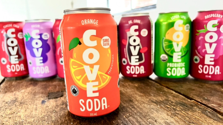 Row of Cove sodas with Orange flavor in the front