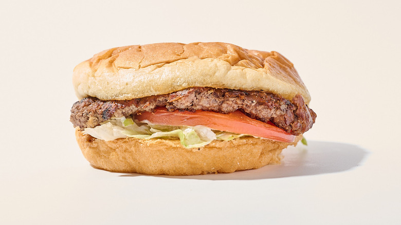 butterburger with lettuce and tomato on a table